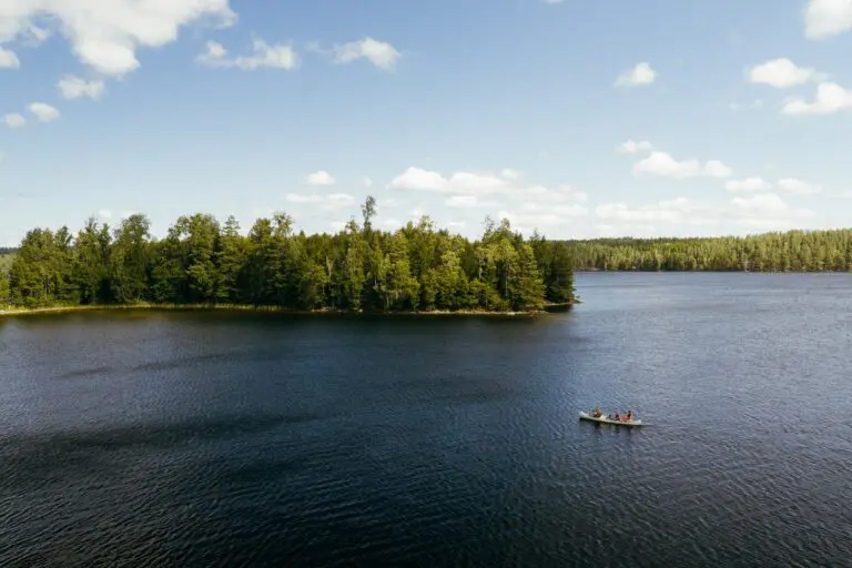 drone shot of people canoeing on a lake in Sweden