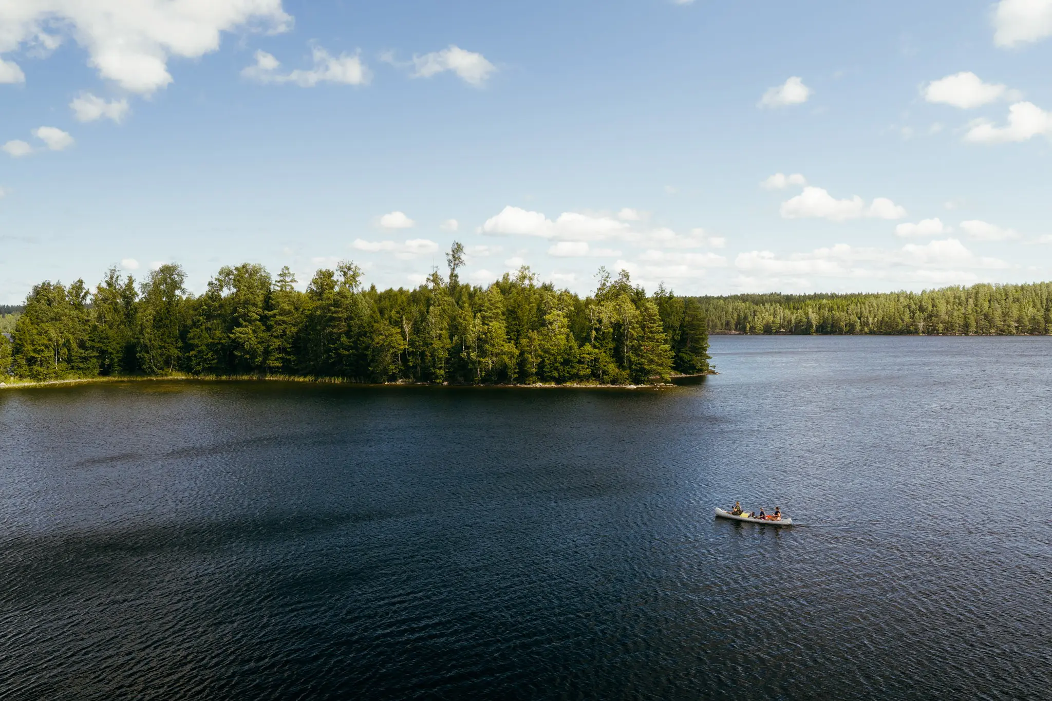 drone shot of people canoeing on a lake in Sweden