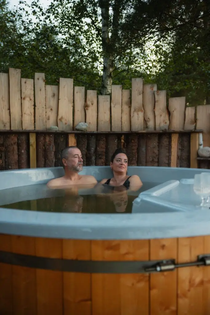 couple relaxing in a hot tub outdoors in Sweden